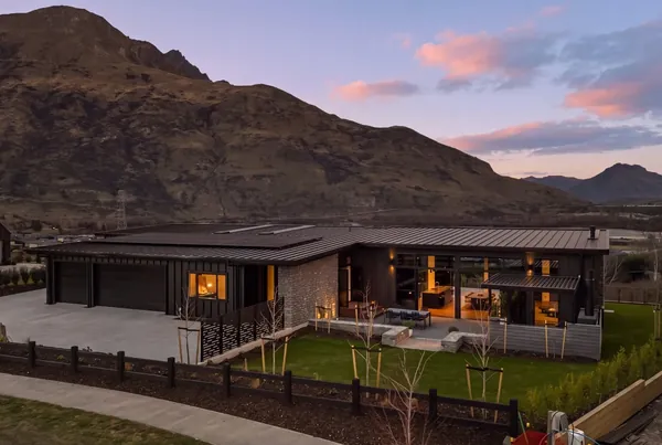 Dusk exterior with the house lit